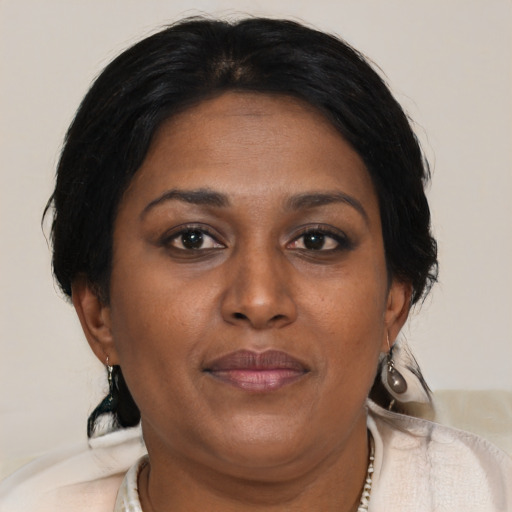 Joyful asian adult female with medium  brown hair and brown eyes