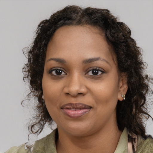 Joyful black young-adult female with medium  brown hair and brown eyes