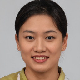 Joyful asian young-adult female with short  brown hair and brown eyes