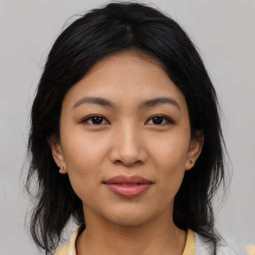 Joyful latino young-adult female with medium  black hair and brown eyes