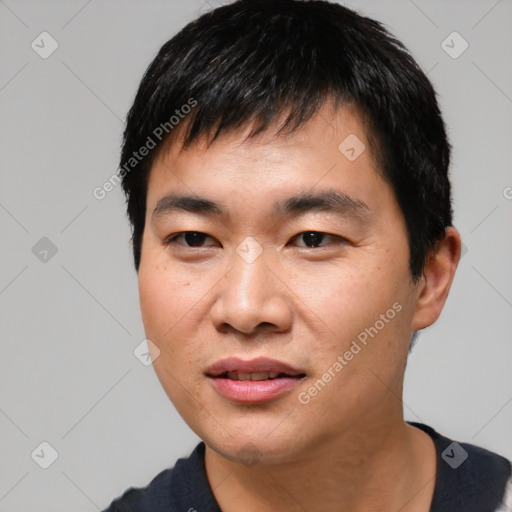 Joyful asian young-adult male with short  black hair and brown eyes