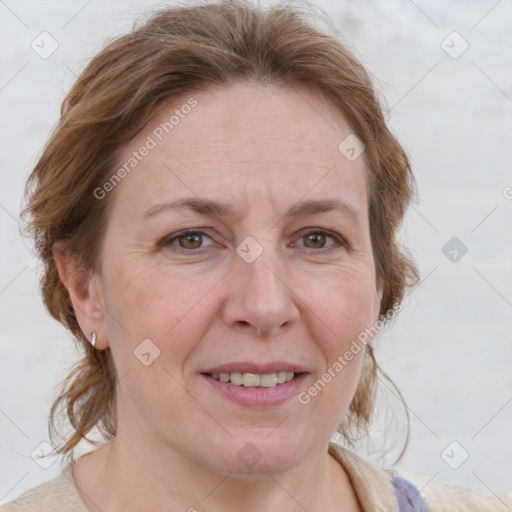 Joyful white adult female with medium  brown hair and blue eyes