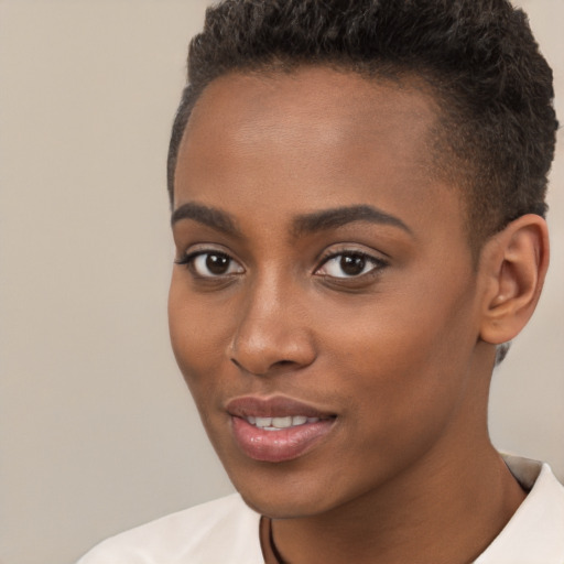 Joyful black young-adult female with short  brown hair and brown eyes