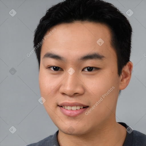 Joyful asian young-adult male with short  black hair and brown eyes