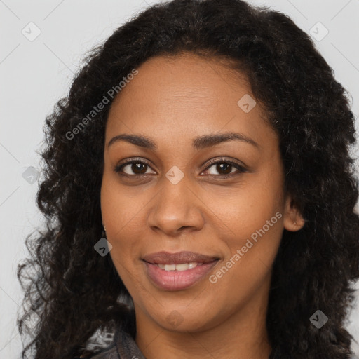 Joyful black young-adult female with long  brown hair and brown eyes