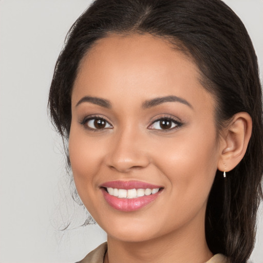 Joyful white young-adult female with long  brown hair and brown eyes