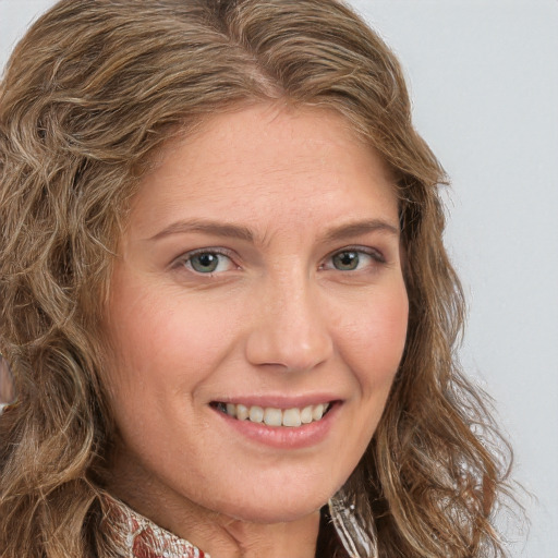 Joyful white young-adult female with long  brown hair and green eyes