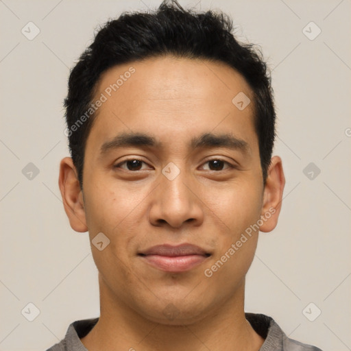 Joyful latino young-adult male with short  black hair and brown eyes