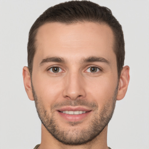 Joyful white young-adult male with short  brown hair and brown eyes