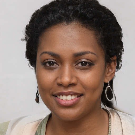 Joyful black young-adult female with short  brown hair and brown eyes