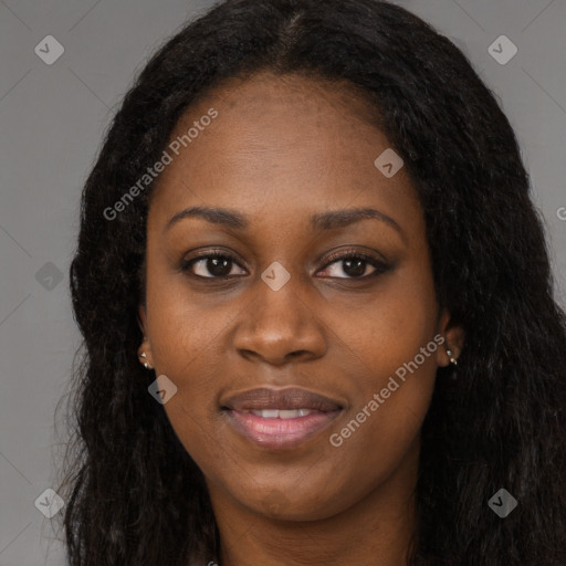 Joyful black young-adult female with long  brown hair and brown eyes