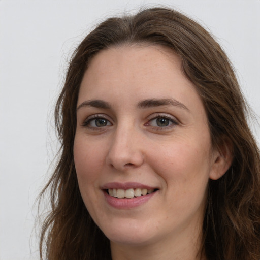 Joyful white young-adult female with long  brown hair and grey eyes