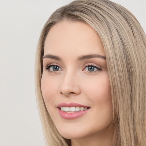 Joyful white young-adult female with long  brown hair and green eyes