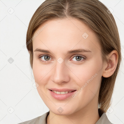 Joyful white young-adult female with medium  brown hair and grey eyes