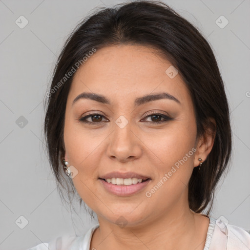 Joyful latino young-adult female with medium  brown hair and brown eyes