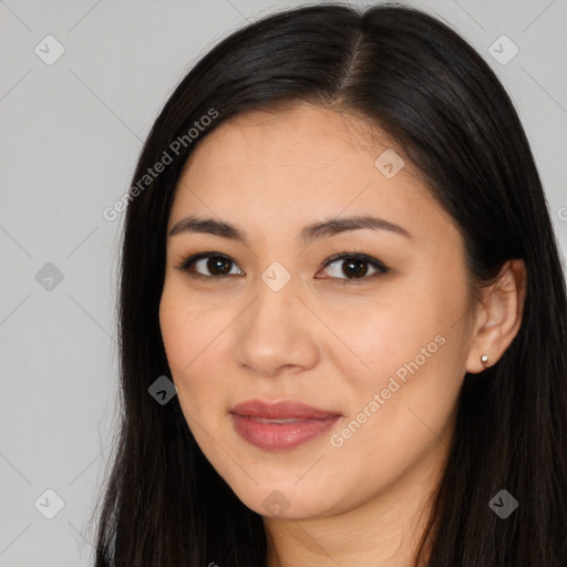 Joyful latino young-adult female with long  brown hair and brown eyes