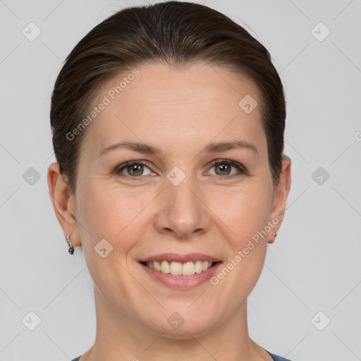 Joyful white adult female with short  brown hair and grey eyes