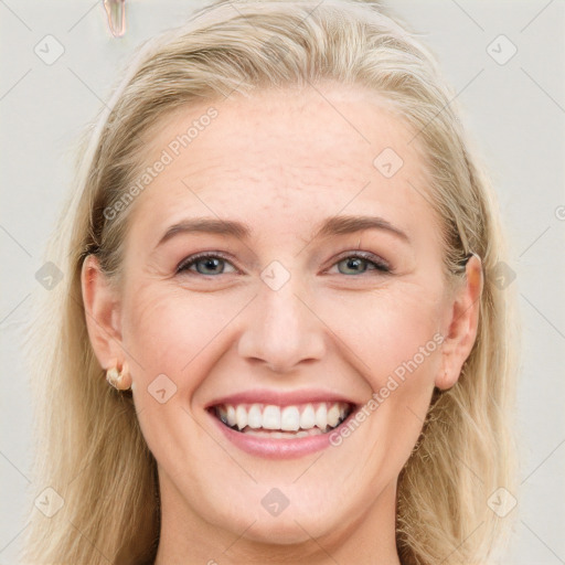 Joyful white young-adult female with long  brown hair and blue eyes