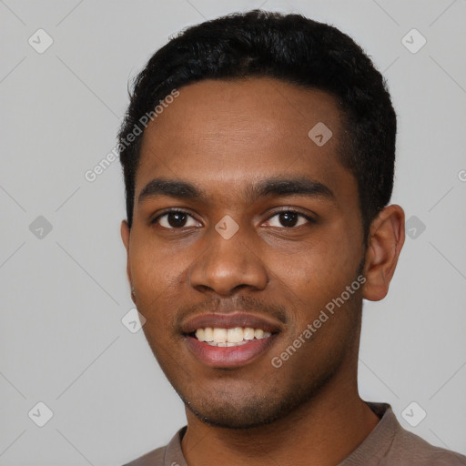 Joyful black young-adult male with short  black hair and brown eyes