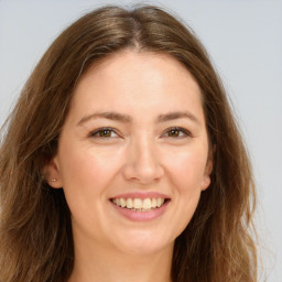 Joyful white young-adult female with long  brown hair and green eyes