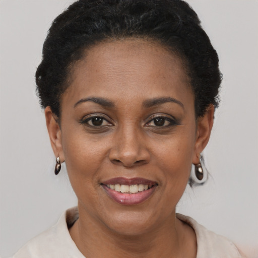 Joyful black young-adult female with short  brown hair and brown eyes