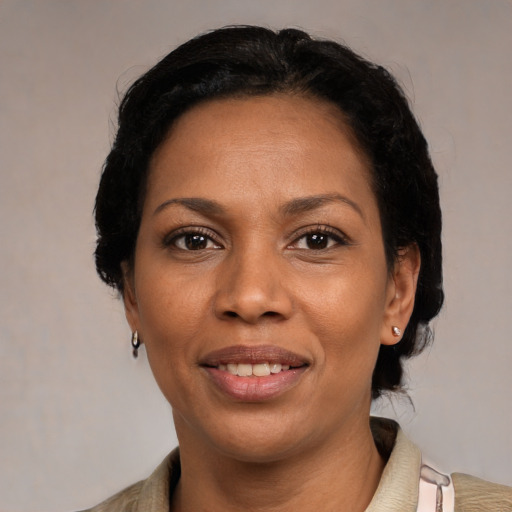 Joyful black adult female with medium  black hair and brown eyes