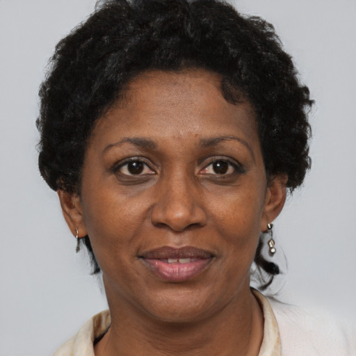 Joyful black adult female with short  brown hair and brown eyes