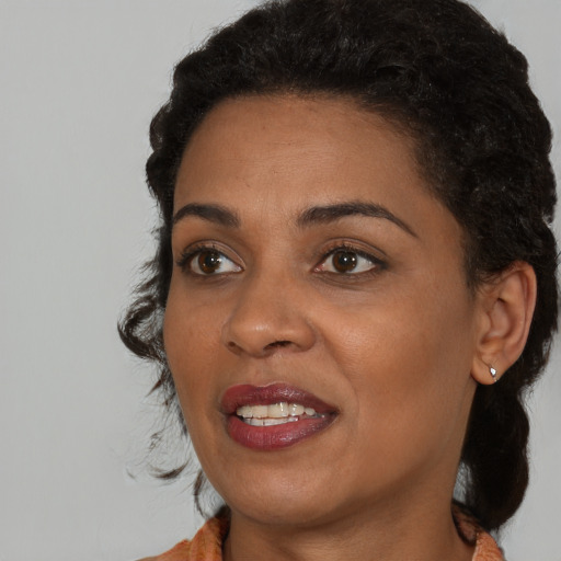 Joyful black young-adult female with medium  black hair and brown eyes