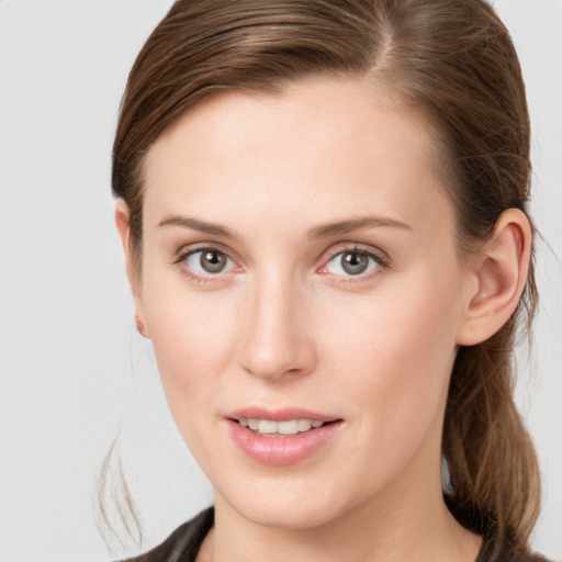 Joyful white young-adult female with medium  brown hair and grey eyes