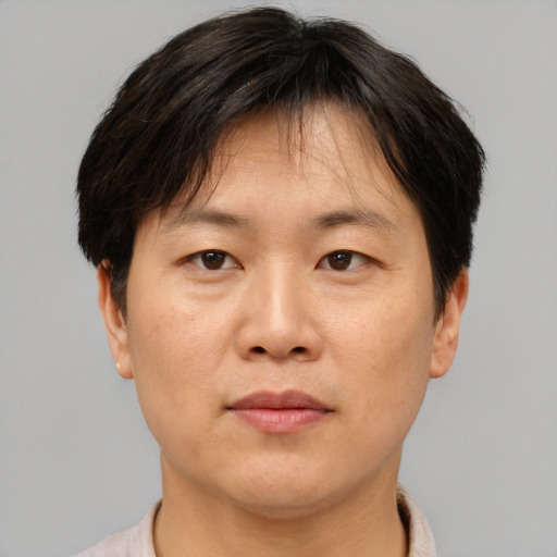 Neutral asian adult male with short  brown hair and brown eyes