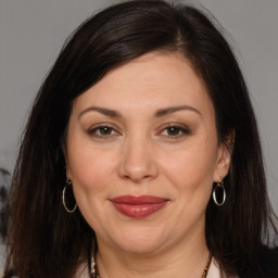 Joyful white adult female with long  brown hair and brown eyes