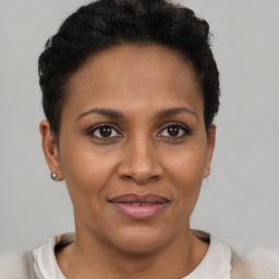 Joyful black adult female with short  brown hair and brown eyes