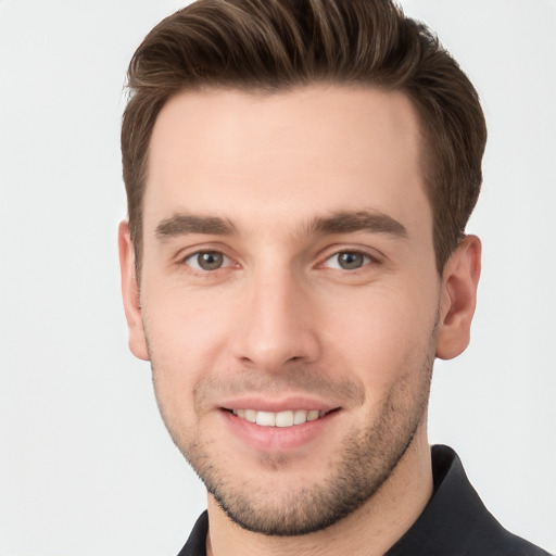 Joyful white young-adult male with short  brown hair and grey eyes