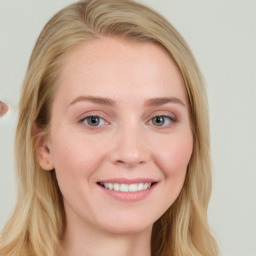 Joyful white young-adult female with long  brown hair and blue eyes