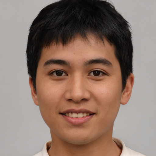 Joyful asian young-adult male with short  brown hair and brown eyes