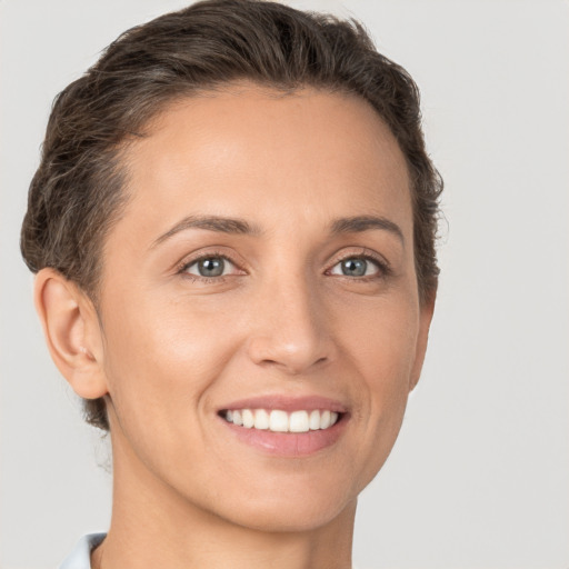 Joyful white young-adult female with short  brown hair and brown eyes