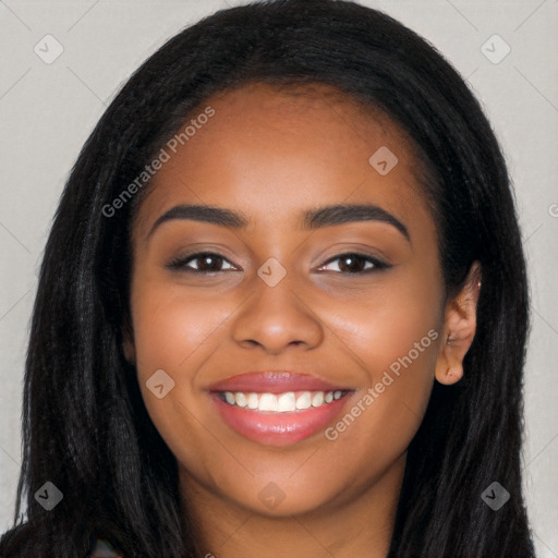 Joyful black young-adult female with long  black hair and brown eyes