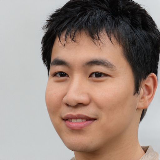 Joyful asian young-adult male with short  black hair and brown eyes