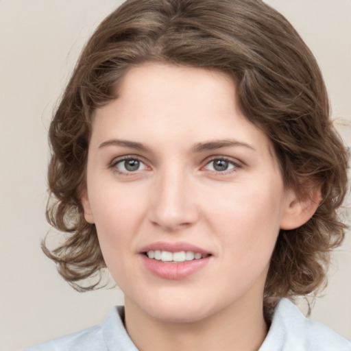 Joyful white young-adult female with medium  brown hair and green eyes