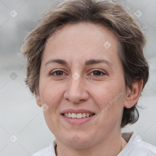 Joyful white adult female with short  brown hair and brown eyes