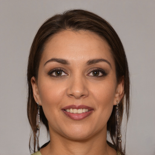 Joyful white young-adult female with medium  brown hair and brown eyes