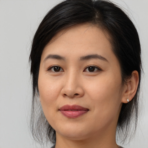 Joyful asian young-adult female with medium  brown hair and brown eyes