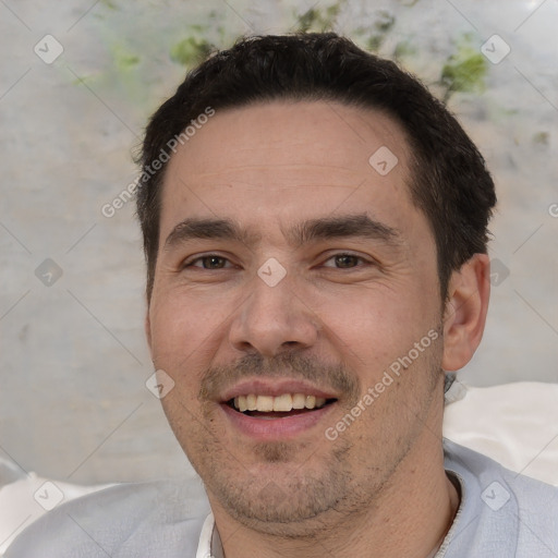 Joyful white adult male with short  black hair and brown eyes