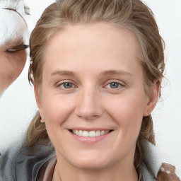 Joyful white young-adult female with medium  brown hair and blue eyes