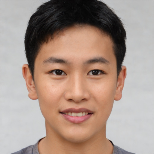 Joyful asian young-adult male with short  brown hair and brown eyes