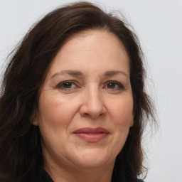 Joyful white adult female with long  brown hair and brown eyes