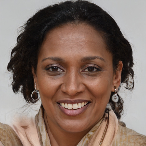 Joyful latino adult female with medium  brown hair and brown eyes