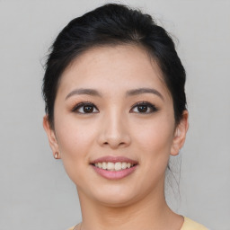 Joyful asian young-adult female with short  brown hair and brown eyes