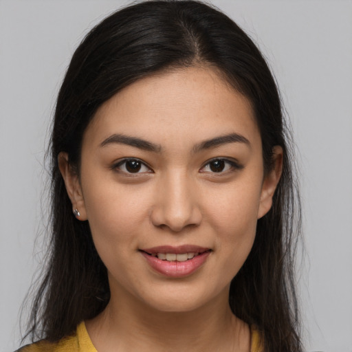 Joyful latino young-adult female with medium  brown hair and brown eyes