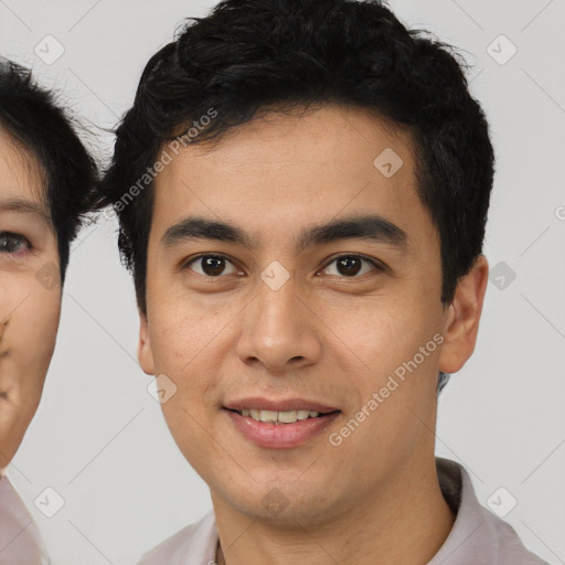 Joyful latino young-adult male with short  brown hair and brown eyes